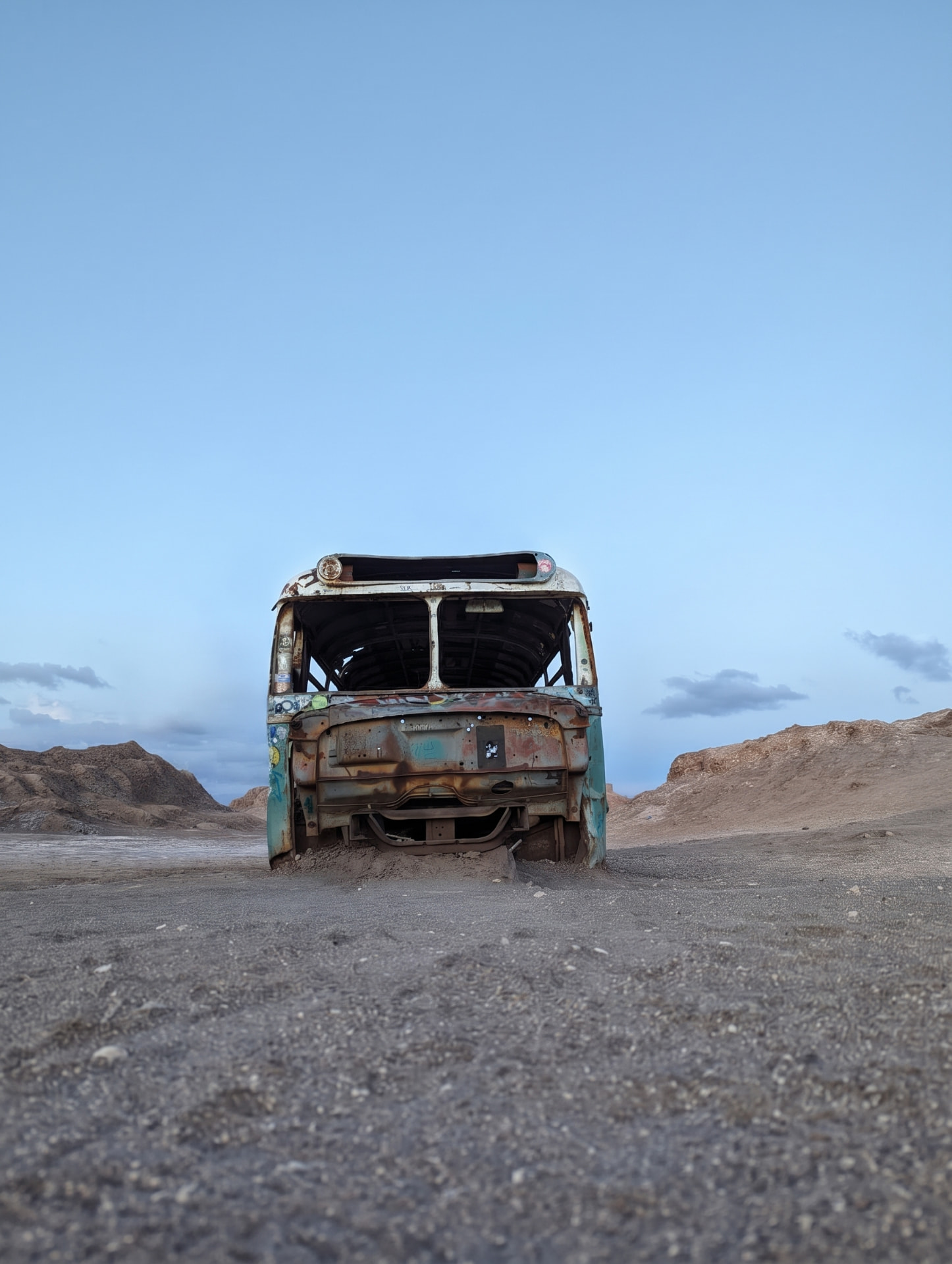 An abandoned bus in a barren landscape
