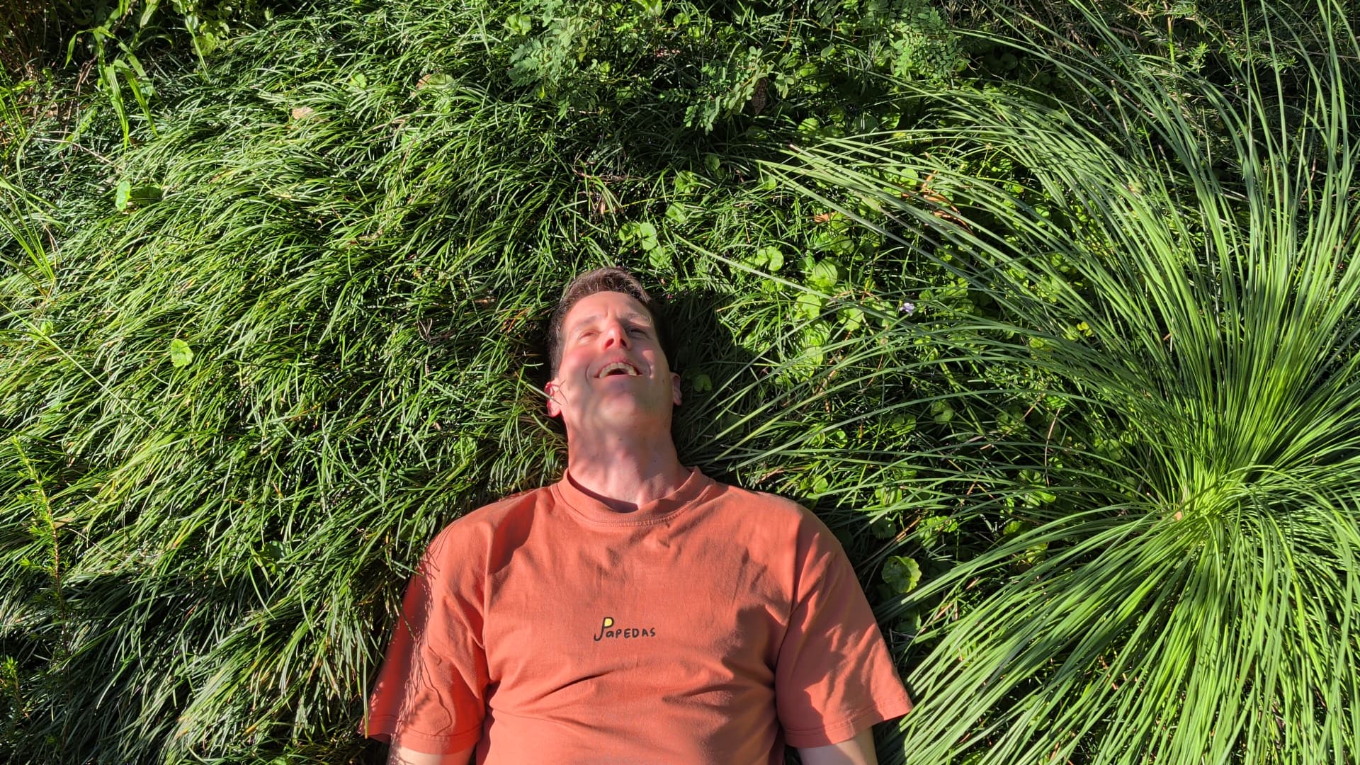 Sean resting in sunlit grass
